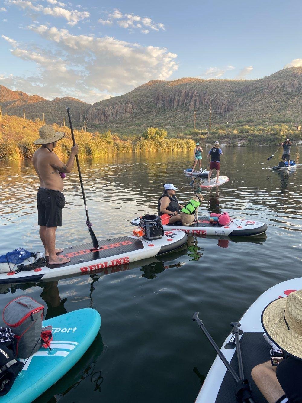 Group paddling Redline boards with a dog on Canyon Lake