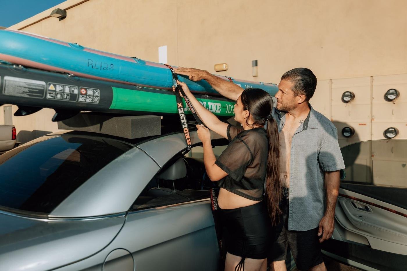 The Redline crew strapping paddleboards onto a customer's car
