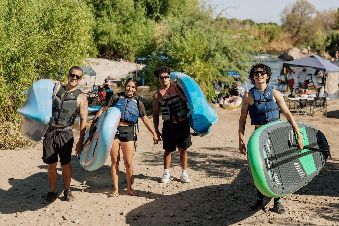 Friends carrying Redline paddleboards to the Lower Salt River